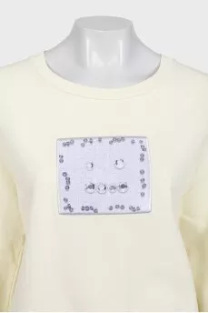 Yellow sweatshirt with a patch on the front