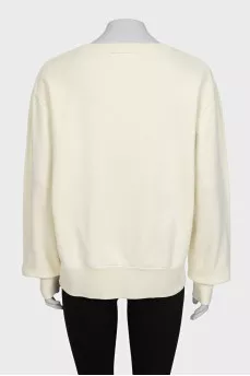 Yellow sweatshirt with a patch on the front
