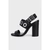 Leather sandals with heels decorated with eyelets