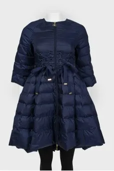 The dark blue jacket is flared up