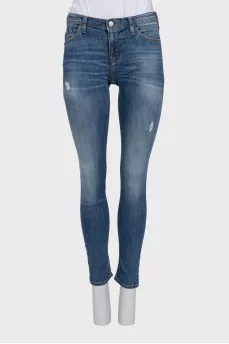 Mid-rise skinny jeans with distressing