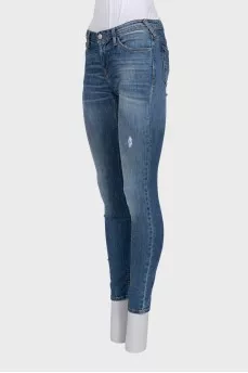 Mid-rise skinny jeans with distressing