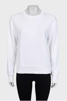 White sweatshirt with a branded patch
