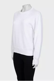 White sweatshirt with a branded patch