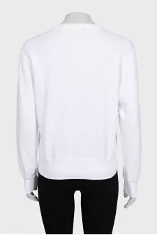 White sweatshirt with a branded patch