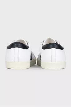 Sneakers with black inserts and a tag
