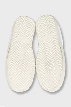 Sneakers with black inserts and a tag