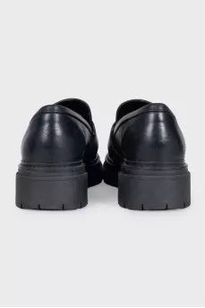 Black leather loafers with signature logo