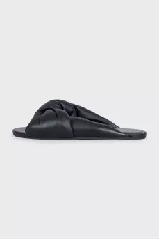 Black leather flip flops with tag