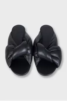 Black leather flip flops with tag