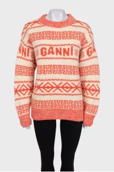 Orange sweater with knitted logo
