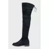 Black suede over-the-knee boots with laces