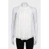White pleated sleeveless blouse