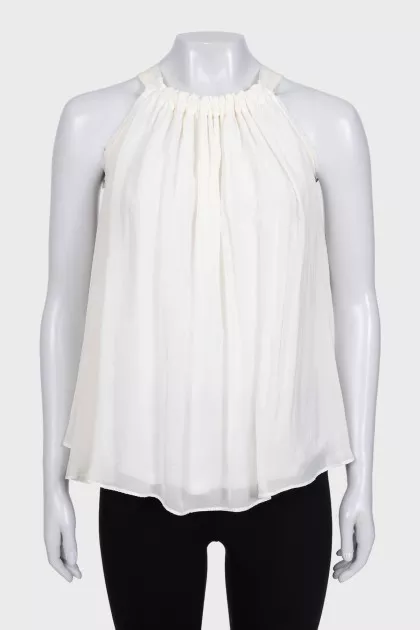 White pleated sleeveless blouse