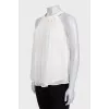 White pleated sleeveless blouse
