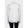 White pleated sleeveless blouse
