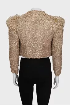 A cropped jacket decorated with crystals and sequins