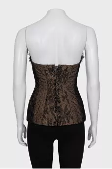 Lace corset top decorated with a bow