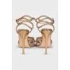 Golden slingbacks decorated with rhinestones