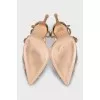 Golden slingbacks decorated with rhinestones