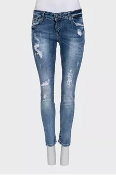 Blue skinny jeans with a distressed effect
