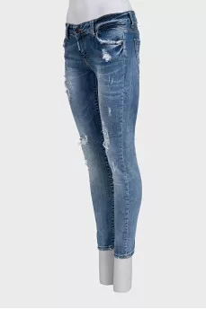 Blue skinny jeans with a distressed effect