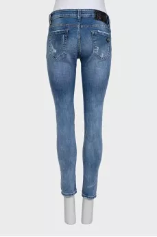 Blue skinny jeans with a distressed effect