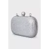 Clutch on a chain decorated with crystals