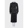Black suit with a pleated skirt with a tag