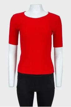 Red top with lacing on the back with a tag