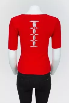 Red top with lacing on the back with a tag
