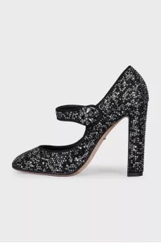 Black suede shoes decorated with starbursts