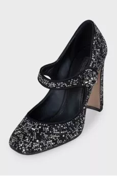 Black suede shoes decorated with starbursts