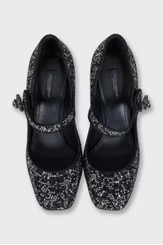 Black suede shoes decorated with starbursts