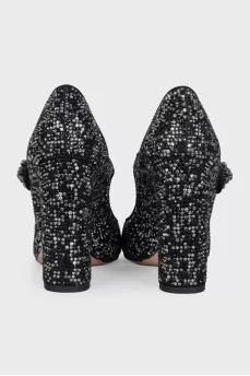 Black suede shoes decorated with starbursts
