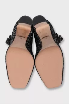 Black suede shoes decorated with starbursts
