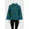Green turtleneck sweater with a printed pattern