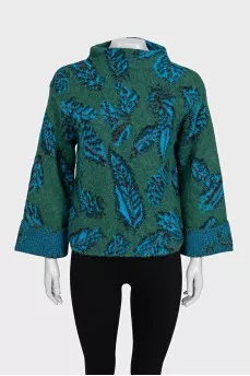 Green turtleneck sweater with a printed pattern