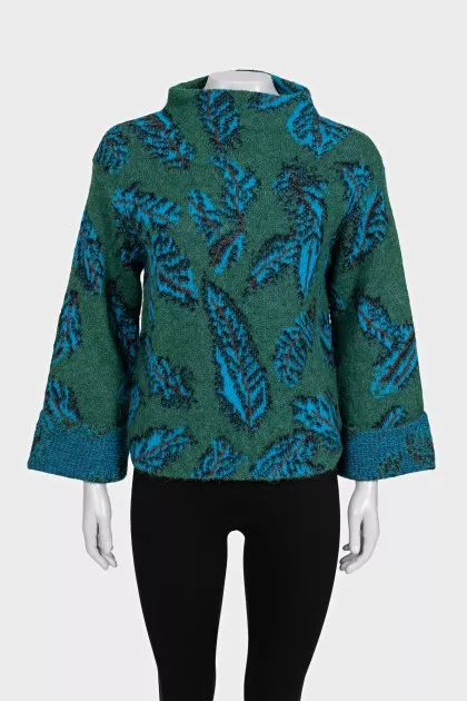 Green turtleneck sweater with a printed pattern