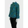 Green turtleneck sweater with a printed pattern