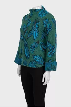 Green turtleneck sweater with a printed pattern
