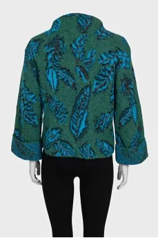 Green turtleneck sweater with a printed pattern