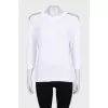 White sweater with shoulder embellishments