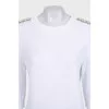 White sweater with shoulder embellishments