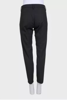 Black tapered trousers with a mid-rise
