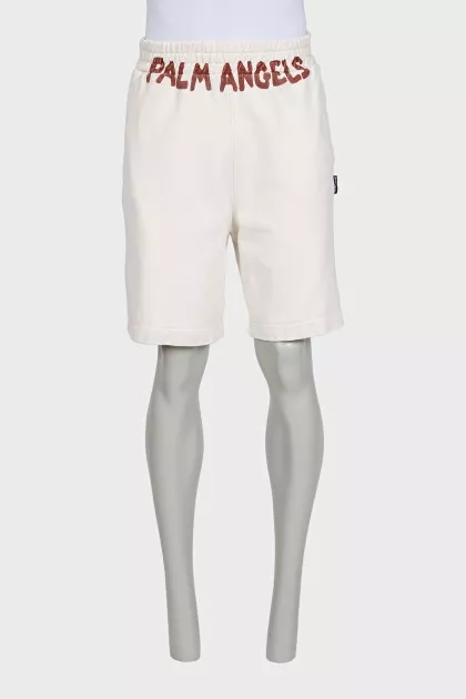 Men's beige shorts with a signature print
