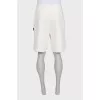 Men's beige shorts with a signature print
