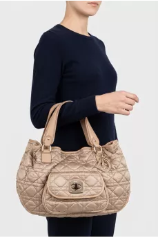 Beige fabric bag with a branded pendant
