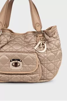 Beige fabric bag with a branded pendant
