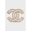 Golden decorated logo brooch
